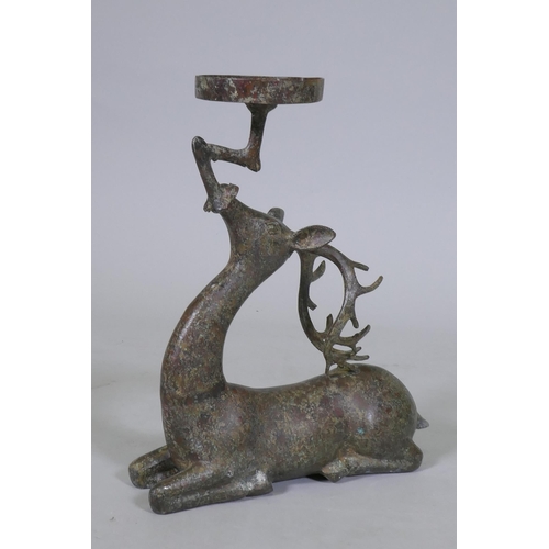 94 - An Eastern patinated bronze censer in the form of a deer, 33cm high