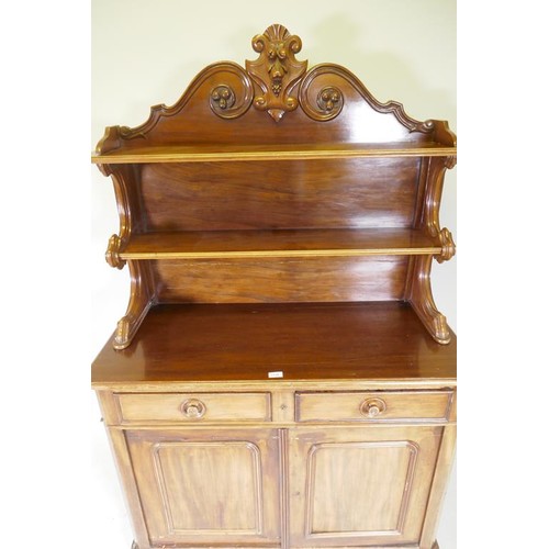 1138 - A C19th mahogany chiffonier, the upper section with two shelves, with carved supports, the lower wit... 