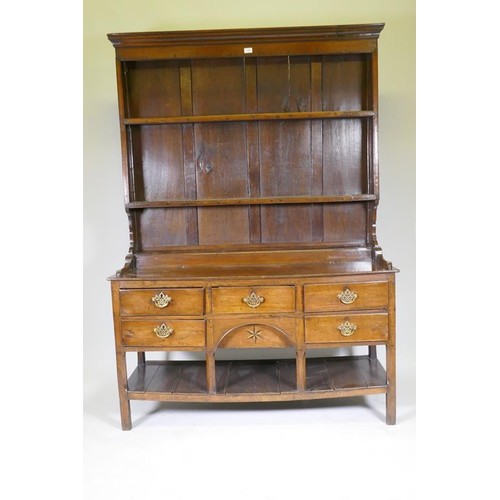 1140 - A good C18th Welsh oak dresser, the enclosed delf rack on a base of five drawers, the middle opening... 