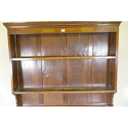 1140 - A good C18th Welsh oak dresser, the enclosed delf rack on a base of five drawers, the middle opening... 