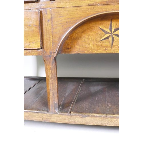 1140 - A good C18th Welsh oak dresser, the enclosed delf rack on a base of five drawers, the middle opening... 