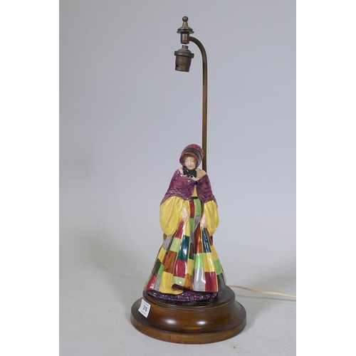 316 - A Royal Doulton 'The Parson's Daughter' porcelain table lamp, marked No HN564, mounted on a wood bas... 