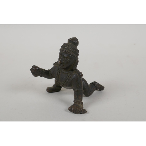 264 - An antique Indian bronze of a crawling figure, 8cm long