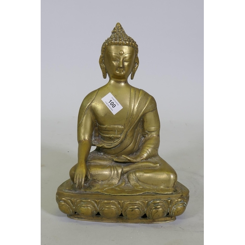 100 - A brass figure of Buddha seated upon a lotus dias, 34cm high