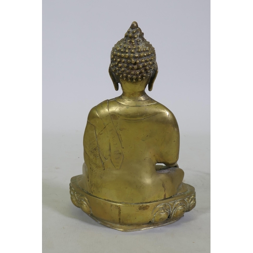 100 - A brass figure of Buddha seated upon a lotus dias, 34cm high