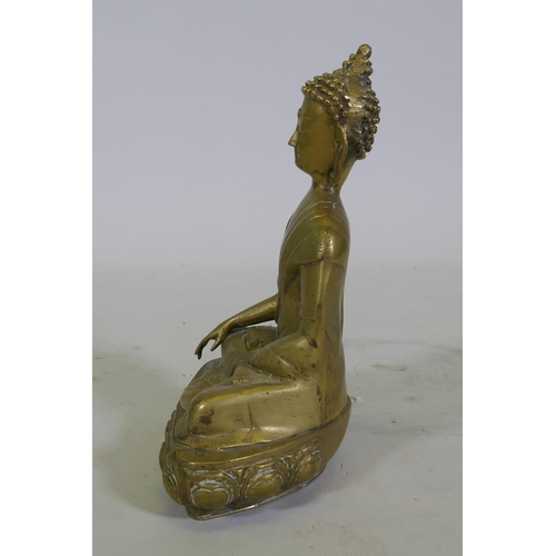 100 - A brass figure of Buddha seated upon a lotus dias, 34cm high