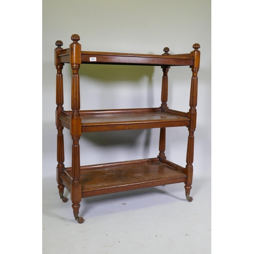 1002 - A Victorian mahogany three tier buffet, raised on reeded supports in the manner of Gillows, 89 x 42 ... 