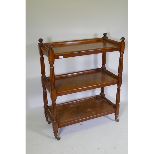 1002 - A Victorian mahogany three tier buffet, raised on reeded supports in the manner of Gillows, 89 x 42 ... 