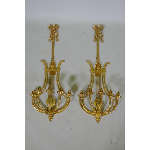 1003 - A pair of ormolu empire style five branch wall sconces of lyre form, 97cm high