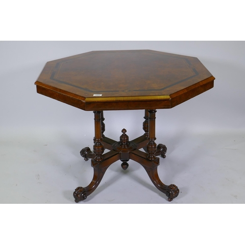 1004 - A Victorian inlaid walnut octagonal tilt top occasional table, raised on four turned columns and cab... 