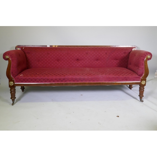 1005 - A C19th Continental mahogany settee, with scrolled arms and brass mounts, raised on turned supports,... 