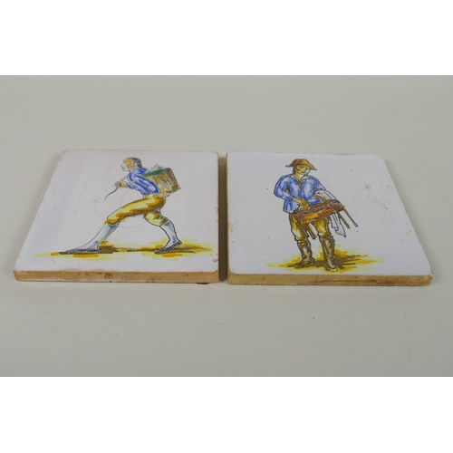 101 - A pair of antique faience tiles decorated with trades people, 14 x 14cm