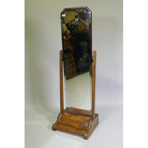 1010 - A 1930s figured walnut cheval mirror, 140cm high