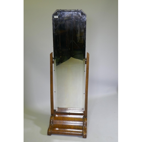 1010 - A 1930s figured walnut cheval mirror, 140cm high