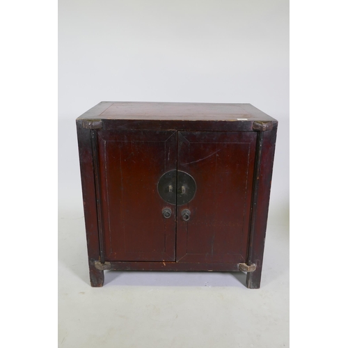 1011 - An antique Chinese red lacquered side cabinet with two doors, 78 x 50cm, 78cm high