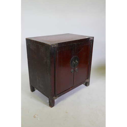 1011 - An antique Chinese red lacquered side cabinet with two doors, 78 x 50cm, 78cm high