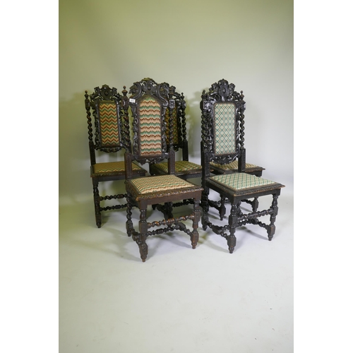 1012 - A set of five Jacobean style carved oak highback chairs