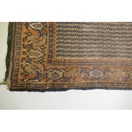 1015 - An antique Persian wool carpet with striped design and red borders, worn, 130 x 190