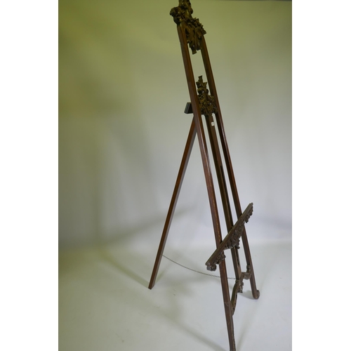 1017 - A carved mahogany adjustable easel, 220cm high