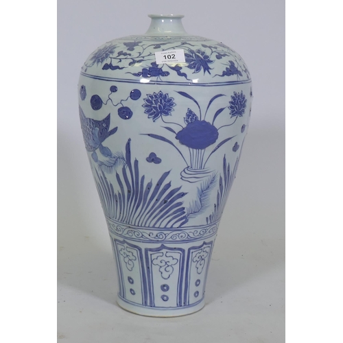 102 - A Chinese blue and white ceramic vase decorated with fish amongst reeds, 42cm high