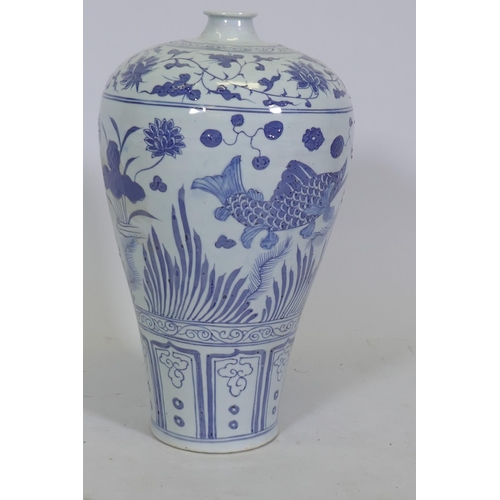 102 - A Chinese blue and white ceramic vase decorated with fish amongst reeds, 42cm high