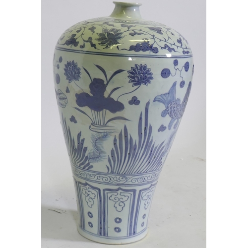 102 - A Chinese blue and white ceramic vase decorated with fish amongst reeds, 42cm high