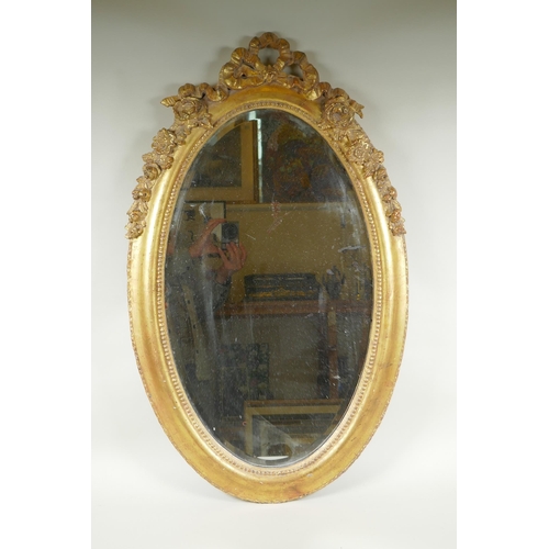 1022 - An antique French oval gilt mirror, with bevelled antique glass, 53 x 87cm