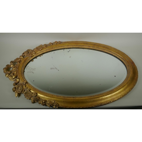 1022 - An antique French oval gilt mirror, with bevelled antique glass, 53 x 87cm