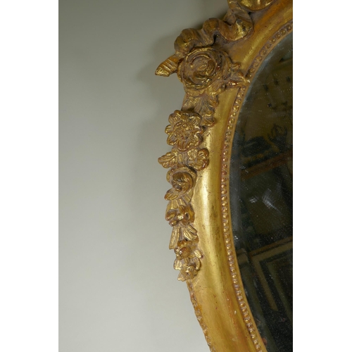 1022 - An antique French oval gilt mirror, with bevelled antique glass, 53 x 87cm