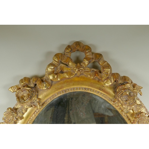 1022 - An antique French oval gilt mirror, with bevelled antique glass, 53 x 87cm