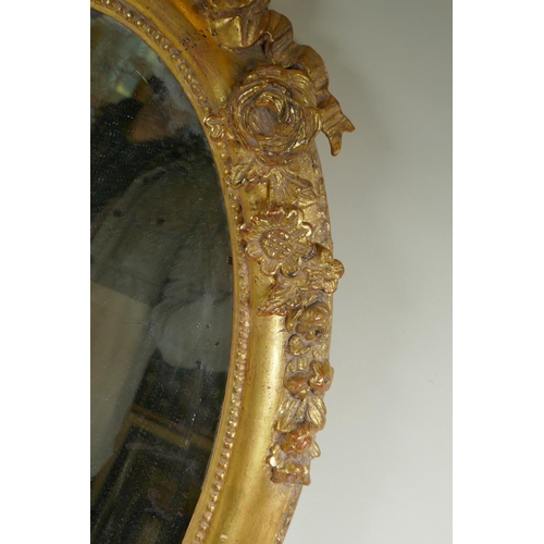 1022 - An antique French oval gilt mirror, with bevelled antique glass, 53 x 87cm