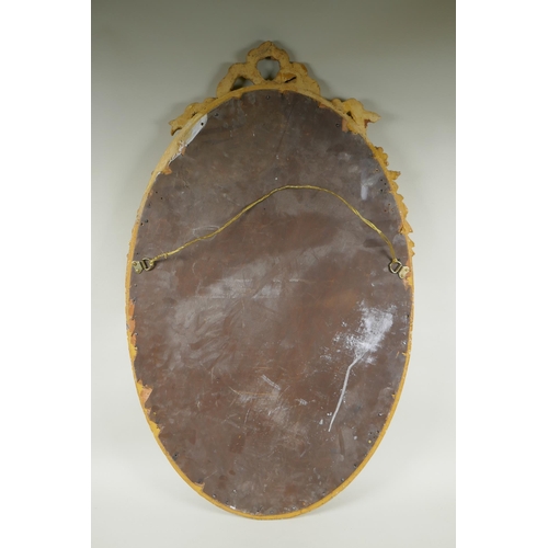 1022 - An antique French oval gilt mirror, with bevelled antique glass, 53 x 87cm