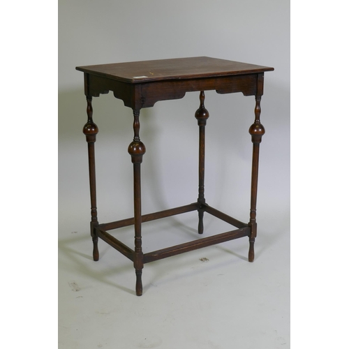 1023 - A Queen Anne style oak lamp table, raised on slender supports with baluster shaped detail, 50 x 38 x... 