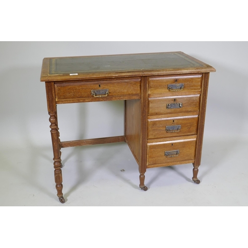 1027 - A Victorian mahogany five drawer desk, with leather inset top, raised on turned supports with castor... 