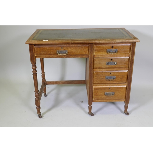 1027 - A Victorian mahogany five drawer desk, with leather inset top, raised on turned supports with castor... 