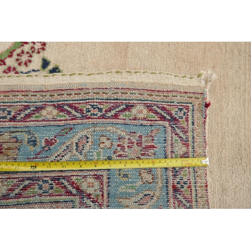 1033 - An Oriental cream ground hand woven wool runner with blue border and floral designs, 150 x 600cm