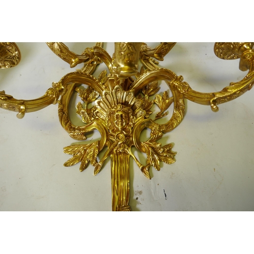 1034 - A pair of ormolu five branch sconces decorated with swags, masks and torches etc 119cm 