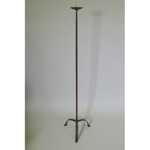 1039 - A wrought iron floor standing pricket candlestick, 129cm high