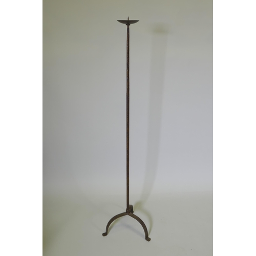 1039 - A wrought iron floor standing pricket candlestick, 129cm high