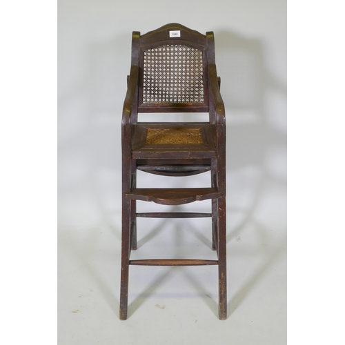 1046 - An oriental hardwood child's highchair with can back and seat, 103cm high