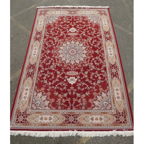 1048 - A fine woven full pile rich red ground Qom carpet, with floral medallion design and floral borders, ... 