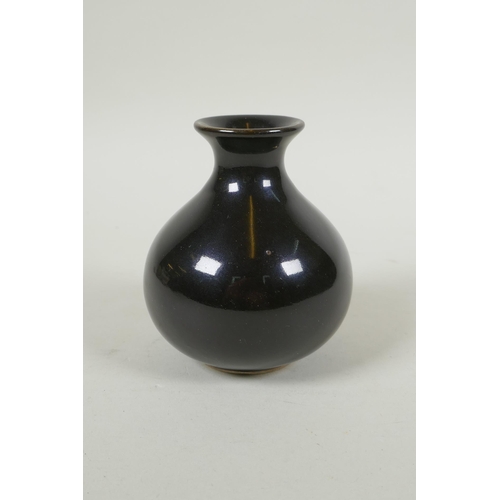 105 - A Chinese treacle glazed porcelain vase of squat form, underglaze marks to the base, 10cm high