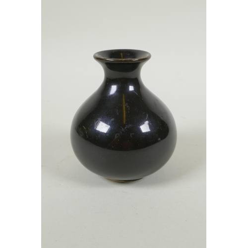 105 - A Chinese treacle glazed porcelain vase of squat form, underglaze marks to the base, 10cm high