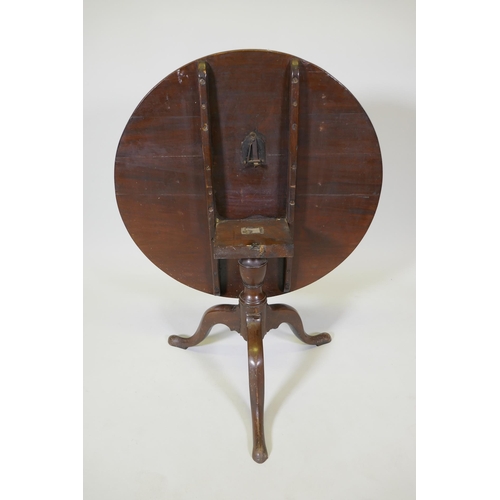 1050 - An antique mahogany tilt top table on tripod supports, reduced, 53cm high x 76cm diameter