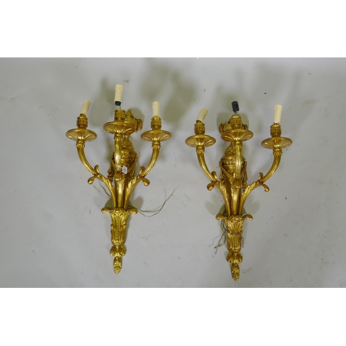 1051 - A pair of ormolu Louis XVI style three branch wall sconces, 66cm