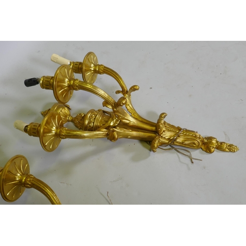 1051 - A pair of ormolu Louis XVI style three branch wall sconces, 66cm