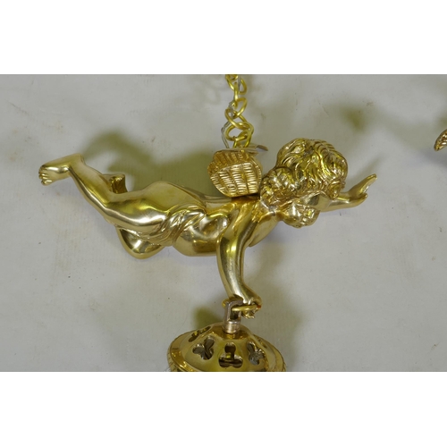 1052 - A pair of French style gilt metal pendant lights in the form of winged putti, with glass lustres, 60... 