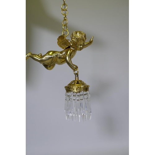 1052 - A pair of French style gilt metal pendant lights in the form of winged putti, with glass lustres, 60... 