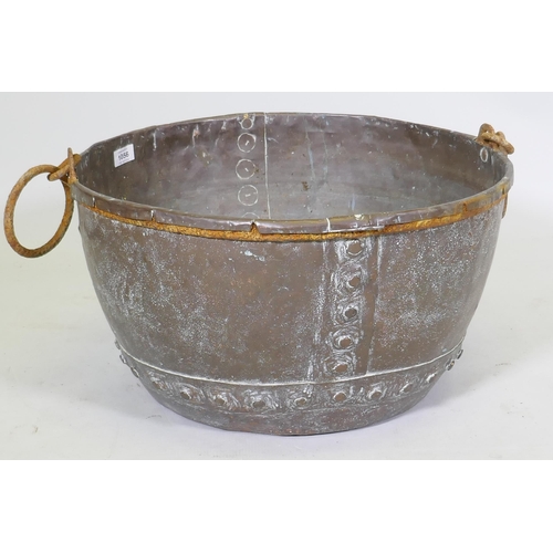 1056 - Antique copper planter with rivetted construction and cast iron handles, 53cm diameter, 30cm high