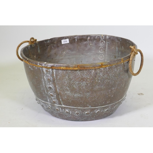 1056 - Antique copper planter with rivetted construction and cast iron handles, 53cm diameter, 30cm high